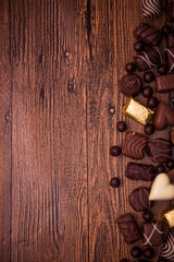 Fototapeta na wymiar Assorted chocolates on wooden background