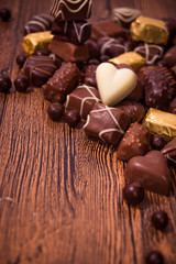 Assorted chocolates on wooden background