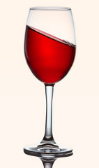 Glass with red liquid frozen at an angle