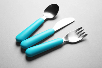 Bright baby tableware on gray background