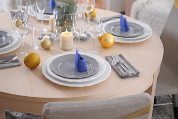 Table served for Christmas dinner in living room, close up view