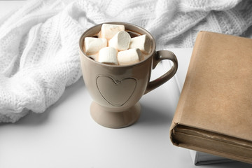 Hot drink with marshmallows on table
