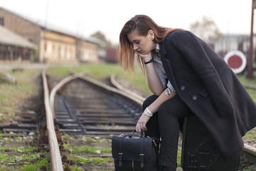 Teenager waiting for a train at the station