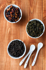 Tea composition. Assortment of dry tea green oolong, black and fruit. Selective focus.Top view.