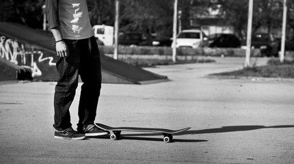 Skater standing on a sunny day creating shadow/Black and white motive
