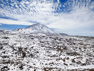 Scenic winter season drone aerial view of Teide volcano covered