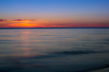 Sunrise at sea shore. Colorful sky.