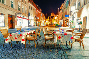 Cityscape and street cafe in Fussen. Bavaria region, Germany. Evening scene.