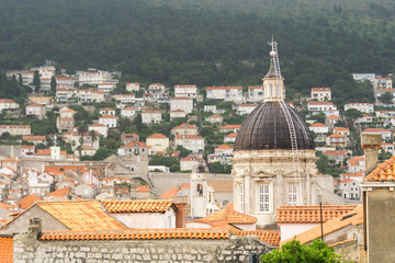 Fototapeta na wymiar Overlooking the terracotta rooftops and the dome of the Church of St. Blaise, the patron saint of Dubrovnik, in the old town.