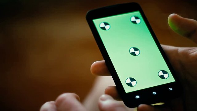 a young man and a green screen smartphone