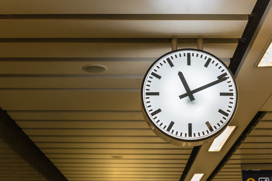 Public big white clock In a railway station