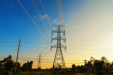 Fototapeta premium silhouette of high voltage electrical pole structure and sunset