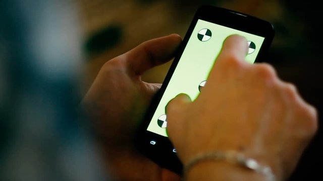 a young man and a green screen smartphone