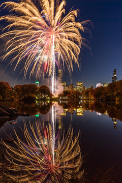 Central Park Fireworks celebrating the Marathon reflecting on the Lake. Midtown Manhattan, New York City