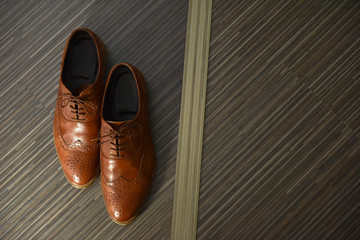 Brown leather man shoes on the floor