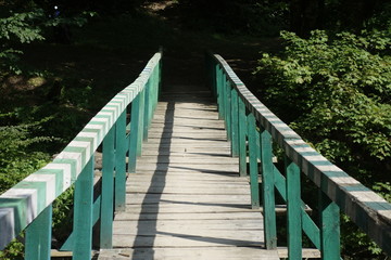 Obraz premium Wooden bridge over mountain river. Transcarpathia