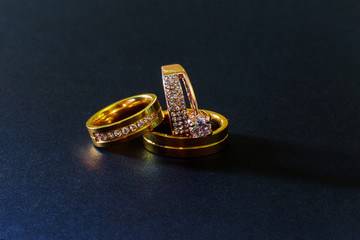 gold wedding rings with diamonds isolated black background