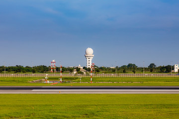 Communication Tower on airport taxi way with blue sky background