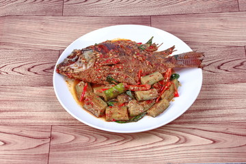 Thai Recipes : Deep-fried tilapia fish  topped Spicy fried eggplant. 