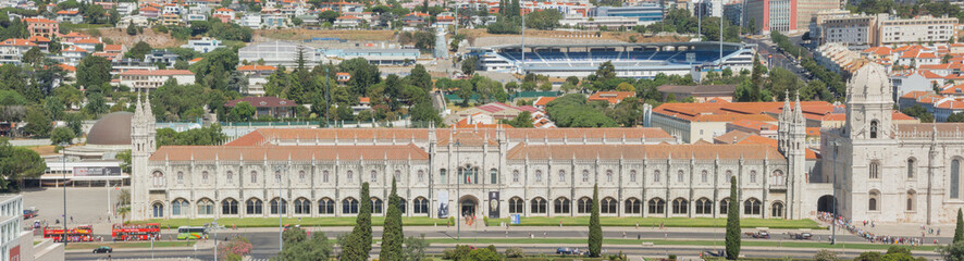 Obraz premium Lisbon, Portugal, September 10, 2016. Landscape from the Monument to the Discoveries (named Padrao dos Descobrimentos) to the Belem tower, Tagus river, 25 de Abril Bridge and Monastery named Jeronimos