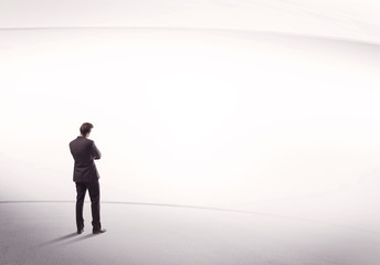 Fototapeta premium Businessman with briefcase standing still