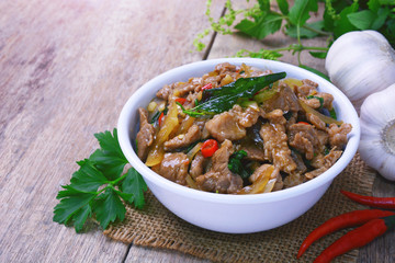 Stir fried hot and spicy sauce with pork, crispy basil leaf on top, served together with aromatic jasmine rice, an authentic popular traditional Thai food.