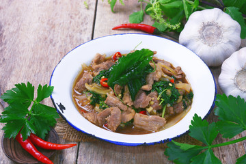 Stir fried hot and spicy sauce with pork, crispy basil leaf on top, served together with aromatic jasmine rice, an authentic popular traditional Thai food.