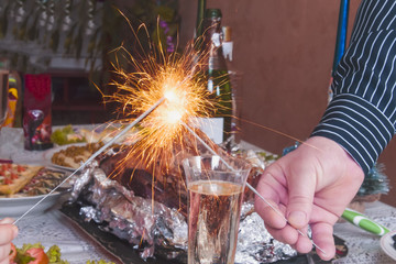 holiday celebration with champagne and sparkler