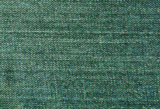 Green jeans textile surface.