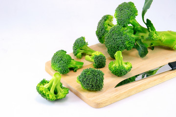 Fresh broccoli on cutting board vegetarian cooking.Broccoli is g