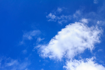 Blue sky background with white clouds. The vast blue sky and clouds sky on sunny day. White fluffy clouds in the blue sky.