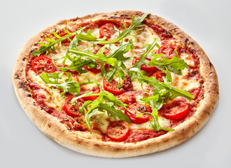 Oven-baked Italian pizza with fresh rocket leaves