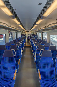 German train interior - Image inside an empty german train wagon with the modern blue chairs disposed on two rows