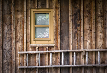 Fototapeta na wymiar A ladder is located at a house or barn of wood.