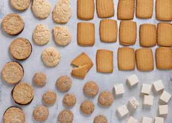 Homemade assorted cookies on baking sheet for the Holidays. Christmas background. Top view.