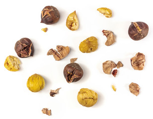 Peeled and unpeeled roasted chestnuts, shot from above on white
