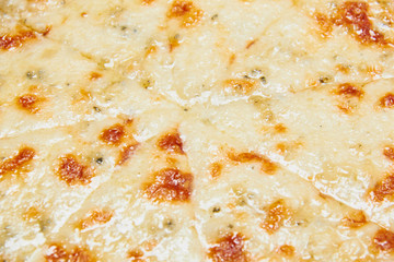 Pizza with three cheeses./Pizza with three cheeses on a wooden board blue.