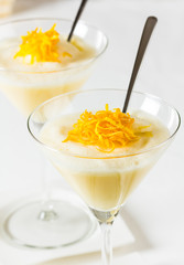 Lemon orange dessert servid in a high glass with spoon