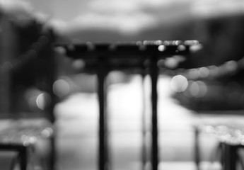 Black and white cafe table with benches bokeh background
