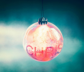 Beautiful lighting Christmas ball with bokeh on turquoise blue background