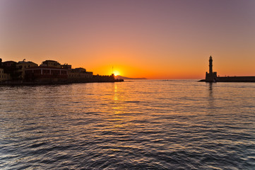 Naklejka premium Sunset at the entrance of old harbor of Hania, island of Crete, Greece
