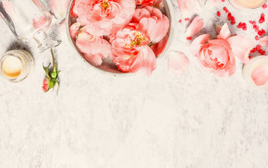 Spa background with roses , bowl with water and petal and cream, top view, border