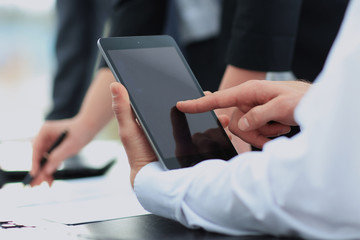 Businessman holding digital tablet at meeting