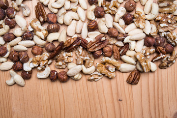 different nuts on wooden ground