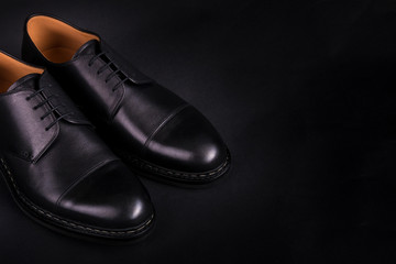 Black oxford shoes on  background. Back view. Copy space.