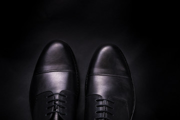 Black oxford shoes on  background. Top view. Copy space.