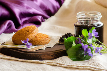 Obraz na płótnie Canvas Cookies with elderberry jam on a purple background