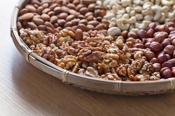 Different nuts in old wooden dish