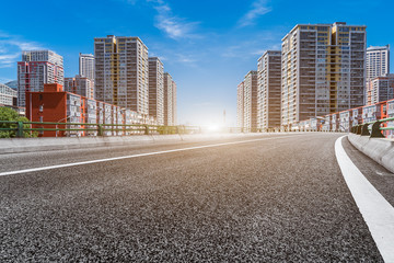 empty asphalt road with cityscape and skyline of Shanghai in China.