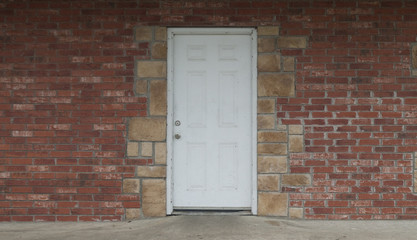 Rustic white door on brick and stone exterior all